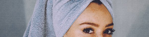 In the picture, the woman looks straight into the eyes, just out of the shower and wearing a hair turban.